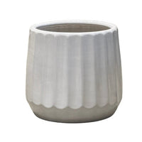 White ceramic planter with ribbed texture on a white background